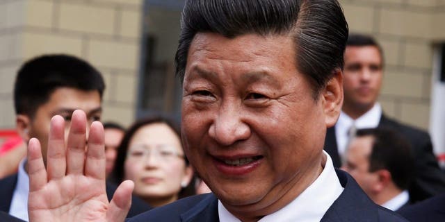 Chinese President Xi Jinping salutes during a visit to a residential complex in Caracas, Venezuela 2014. The Chinese president has visited Latin America more times in the past decade than former presidents Obama, Trump and current president Biden combined. 
