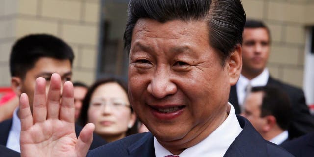 Chinese President Xi Jinping salutes during a visit to a residential complex in Caracas, Venezuela 2014. The Chinese president has visited Latin America more times in the past decade than former presidents Obama, Trump and current president Biden combined. 