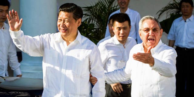 Cuban President Raul Castro, right, stands next to Chinese President Xi Jinping, left, in Santiago de Cuba on July 23, 2014. Xi ended an eight-day trip through Latin America on Wednesday with a visit to eastern Cuba, the island's independence.  The struggle against Spain and the revolution of Fidel Castro began.