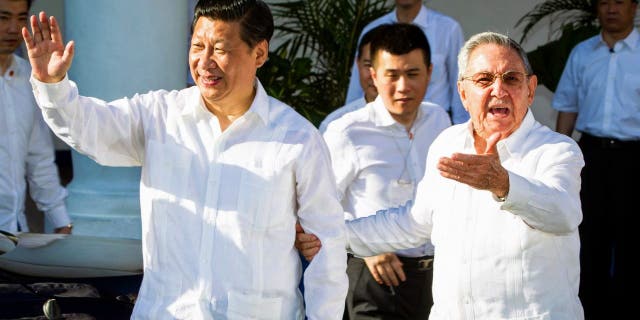 Cuban President Raul Castro, right, stands next to Chinese President Xi Jinping, left, in Santiago de Cuba July 23, 2014. Xi concluded an eight-day trip through Latin America on Wednesday with a visit to eastern Cuba , where both the independence of the island began the struggle against Spain and the revolution of Fidel Castro.