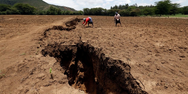 Women work on their farm near a chasm suspected to have been caused by a heavy downpour along an underground fault line near the Rift Valley town of Mai Mahiu, Kenya, March 28, 2018.