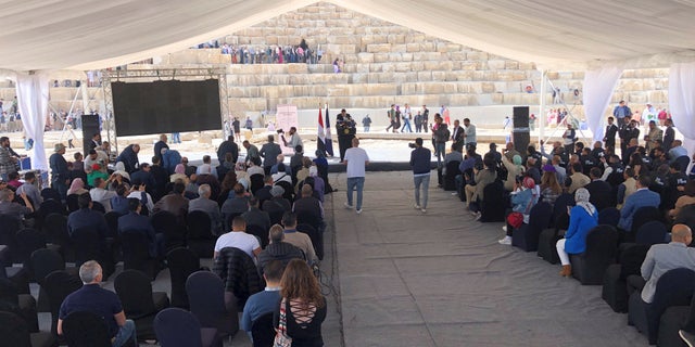 Egyptian Minister of Tourism and Antiquities Ahmed Issa talks to the media in front of the Great Pyramid of Giza.