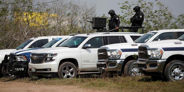 Police officers monitor the site where authorities found the bodies of two of four Americans who were kidnapped by gunmen, in Matamoros, Mexico on March 7, 2023.