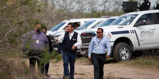 Tamaulipas attorney general's office personnel walk at the scene where authorities found the bodies of two of four Americans kidnapped by gunmen, in Matamoros, Mexico March 7, 2023.