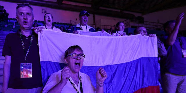 Russians cheer boxer Anna Aedma during her match against Monique Suraci of Australia, in the Round of 32 of the elite women 50-52kg fly weight category, at the Women's World Boxing Championships, at Indira Gandhi Indoor stadium in New Delhi, India, March 16, 2023.