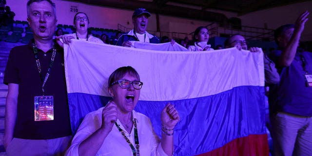 Russians cheer boxer Anna Aedma during her match against Monique Suraci of Australia, in the Round of 32 of the elite women 50-52kg fly weight category, at the Women's World Boxing Championships, at Indira Gandhi Indoor stadium in New Delhi, India, March 16. , 2023.