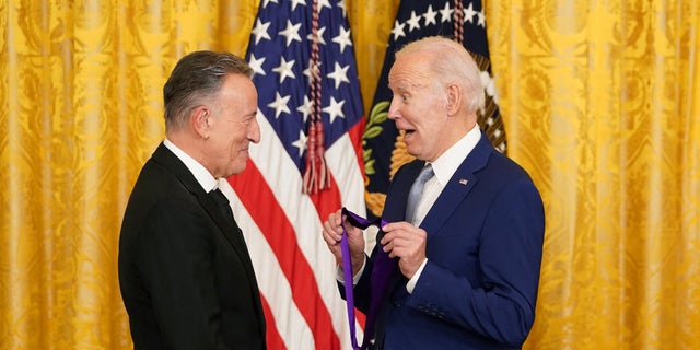 U.S. President Joe Biden presents singer Bruce Springsteen with a National Medal of Arts during a ceremony in the East Room at the White House in Washington, U.S., March 21, 2023. REUTERS/Kevin Lamarque
