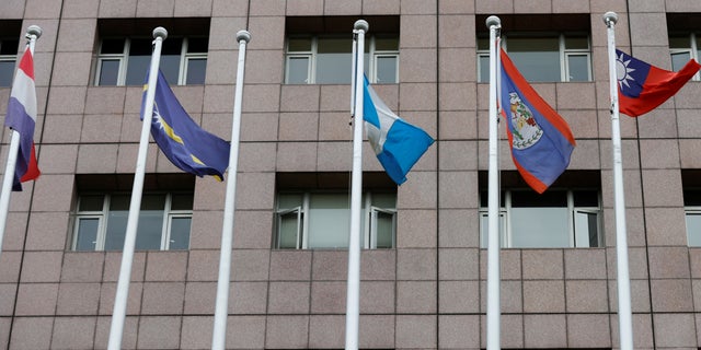An empty flag pole where the Honduran flag used to fly is pictured next to flags of other countries at the Diplomatic Quarter which houses embassies in Taipei, Taiwan March 26, 2023.