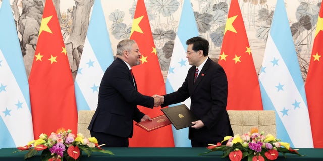 Chinese Foreign Minister Qin Gang shake hands with Honduras Foreign Minister Eduardo Enrique Reina during the ceremony of establishment of diplomatic relations between the two countries at Diaoyutai State Guesthouse March 26, 2023, in Beijing, China.