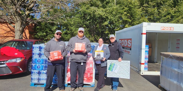 Captain Angelica Spence (second from right, above) holds supplies, along with staff members from Superior Beverage.