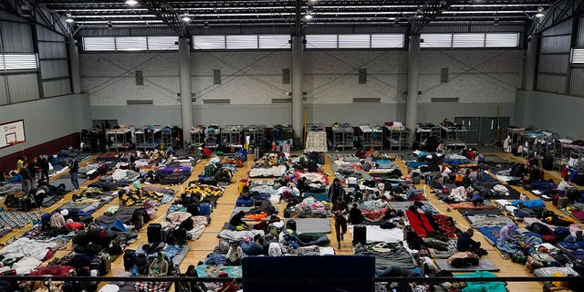 Ukrainian refugees wait in a gymnasium on April 5, 2022, in Tijuana, Mexico. Thousands of Ukrainians entered the U.S. from Mexico to receive American sanctuary.
