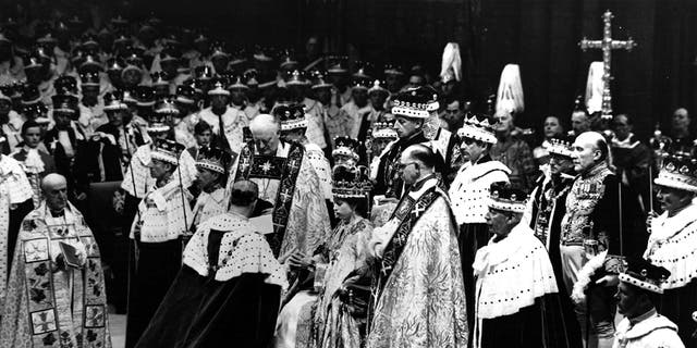 Prince Philip, the Duke of Edinburgh, is seen here paying homage to Queen Elizabeth II during her coronation in 1953.