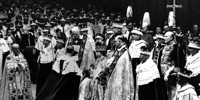 Prince Philip, the Duke of Edinburgh, is seen here paying homage to Queen Elizabeth II during her coronation in 1953.