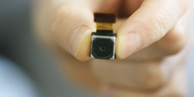 Person holds a small camera