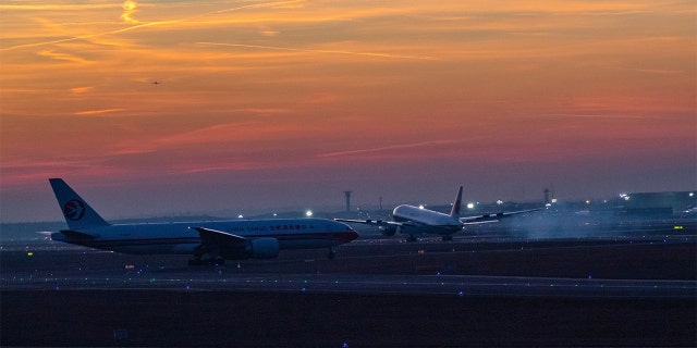 Airplane on tarmac during sunset