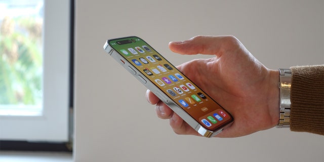 Person holds an iPhone