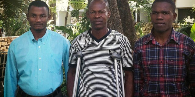 David Boniface, Nissage Martyr and Juders Yseme, from left, pose together in January 2014, in Haiti. Boniface, Yseme, and Martyr's son Nissandere are plaintiffs in a suit against former Les Irois, Haiti, Mayor Jean Morose Viliena, who is accused of terrorizing his political opponents.