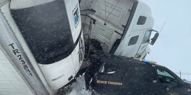 The South Dakota State Trooper's cruiser was crushed by the semi-truck on Interstate 90.