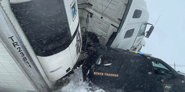 The South Dakota State Trooper's cruiser was crushed by the semi-truck on Interstate 90.