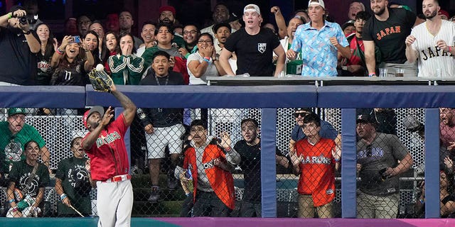 Mexico left fielder Randy Arozarena catches a ball hit by Japan's Kensuke Kondoh during the fifth inning of a World Baseball Classic game, Monday, March 20, 2023, in Miami.