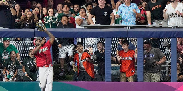 Mexico left fielder Randy Arozarena catches a ball hit by Japan's Kensuke Kondoh during the fifth inning of a World Baseball Classic game, Monday, March 20, 2023, in Miami.