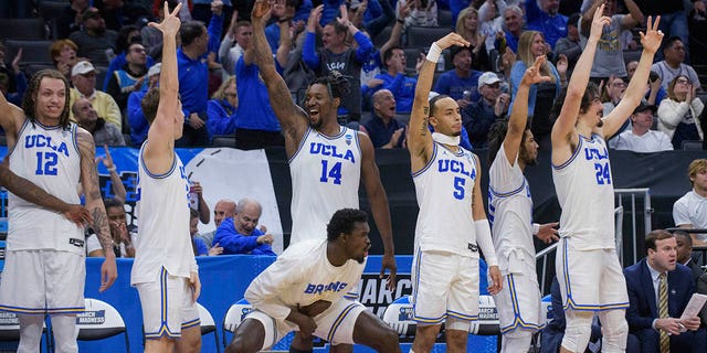 UCLA players celebrate near the end of a win in a first round college basketball game against UNC Asheville in the NCAA Men's Tournament in Sacramento, California on Thursday, March 16, 2023. 