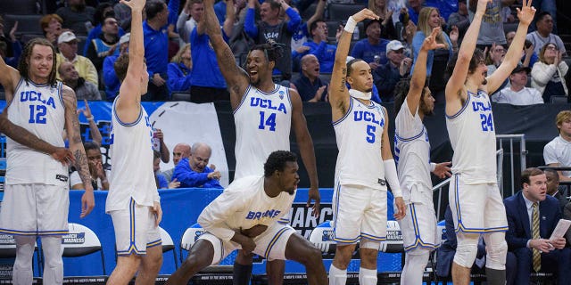 UCLA players celebrate near the end of a win in a first round college basketball game against UNC Asheville in the NCAA Men's Tournament in Sacramento, California on Thursday, March 16, 2023. 