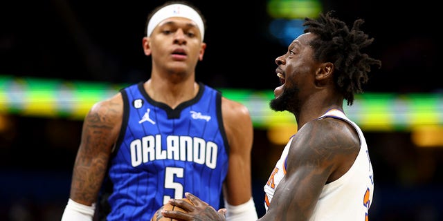 Julius Randle of the New York Knicks, right, drives against the Orlando Magic during the first quarter at Amway Center March 23, 2023, in Orlando, Fla.