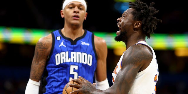 Julius Randle of the New York Knicks, right, drives against the Orlando Magic during the first quarter at Amway Center March 23, 2023, in Orlando, Fla.