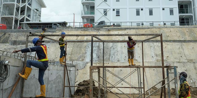 Indonesia is planning to move its capital from Jakarta to the island of Borneo. Workers build a metal structure at the construction site of the new capital city in Indonesia, on March 8, 2023. 