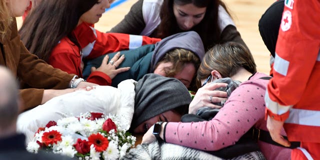 Relatives cry on the coffin of one of the victims of last Sunday's shipwreck in Crotone, Italy, on March 1, 2023.