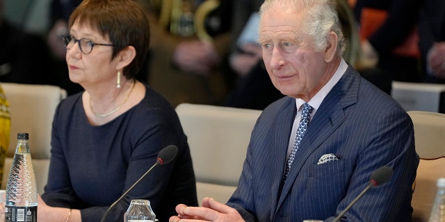 King Charles III is seen meeting with Turkish and Ukrainian staff during a visit to the European Bank for Reconstruction and Development on March 23, 2023, in London. The king will be in Germany on Wednesday.