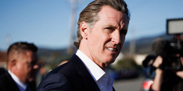 California Gov. Gavin Newsom heads to a press conference in Half Moon Bay, California, on Jan. 24, 2023.