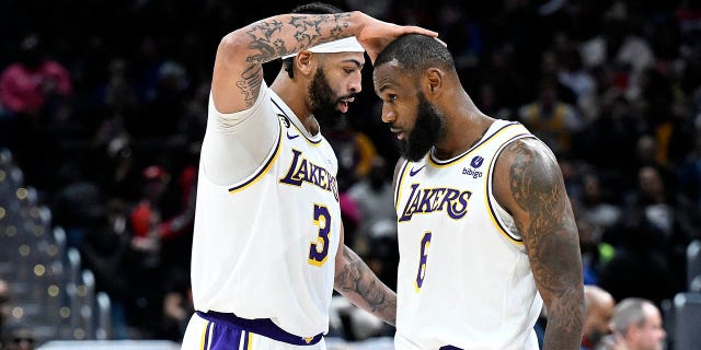 Anthony Davis (3) and LeBron James (6) of the Los Angeles Lakers celebrate during the fourth quarter against the Washington Wizards at Capital One Arena Dec. 4, 2022, in Washington, D.C.