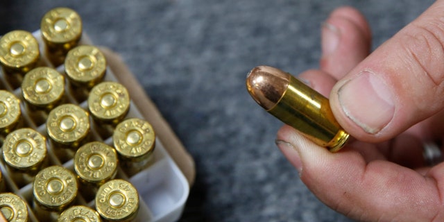 Chris Puehse, owner of Foothill Ammo, displays .45-caliber ammunition for sale at his store in Shingle Springs, California, on June 11, 2019.