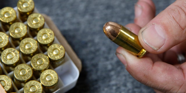 Chris Puehse, owner of Foothill Ammo, displays .45-caliber ammunition for sale at his store in Shingle Springs, California, on June 11, 2019.