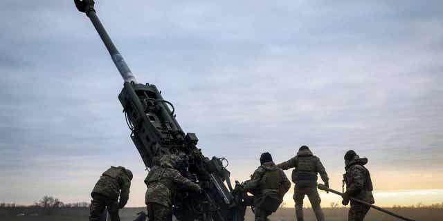 Ukrainian soldiers prepare a U.S.-supplied M777 howitzer to fire at Russian positions in Ukraine on Jan. 9, 2023. European Union officials are trying to speed up the delivery of Howitzer ammunition rounds to Ukraine.