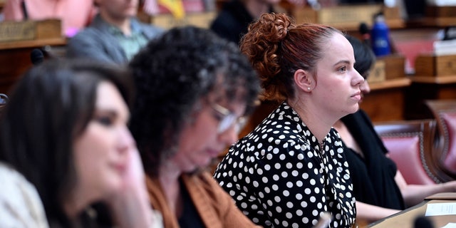 Catherine Jones watches people speak during public hearing in the House of Delegates Chamber for a bill that would codify the right of West Virginia residents to challenge government regulations that interfere with their religious beliefs, Friday, Feb. 24, 2023.