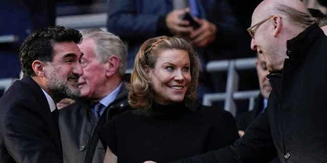 Manchester United's Chairman Avie Glazer, right, and Newcastle United's Chairman Yasir Al-Rumayyan, left, shake hands before the English League Cup final soccer match in London on Feb. 26, 2023. The Premier League is being urged to look into the details of the deal made between Newcastle United and Saudi Arabia's sovereign wealth fund.