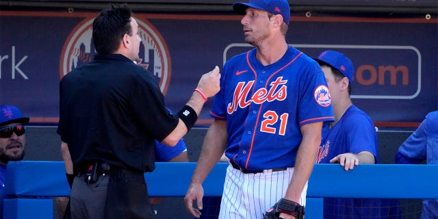New York Mets starting pitcher Max Scherzer (21) talks with home plate umpire David Rackley after working during the second inning of a spring training baseball game against the Washington Nationals Sunday, Feb. 26, 2023, in Port St. Lucie, Fla.