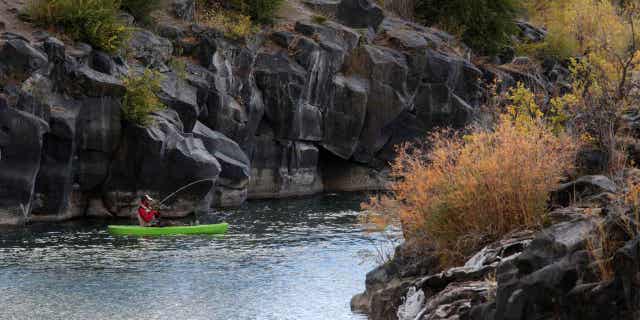 A man hooks a fish in Idaho Falls, Idaho on Oct. 11, 2020. Idaho joined a Texas lawsuit against the Biden administration's waterway protections.