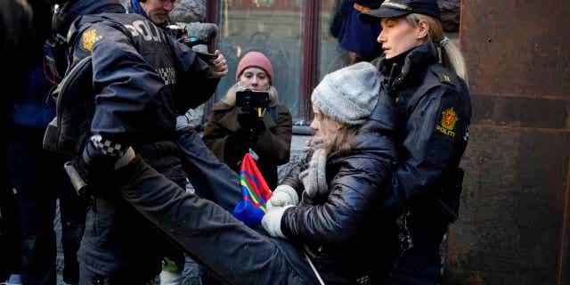 Swedish activist Greta Thunberg is carried away during a protest outside the Norwegian Ministry of Finance, in Oslo, on March 1, 2023. Norway's energy minister canceled his trip to the United Kingdom due to the protests.