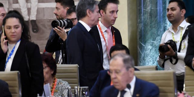 Secretary of State Antony Blinken, top center, walks past Russian Foreign Minister Sergey Lavrov during the G-20 foreign ministers meeting in New Delhi on Thursday, March 2, 2023. 