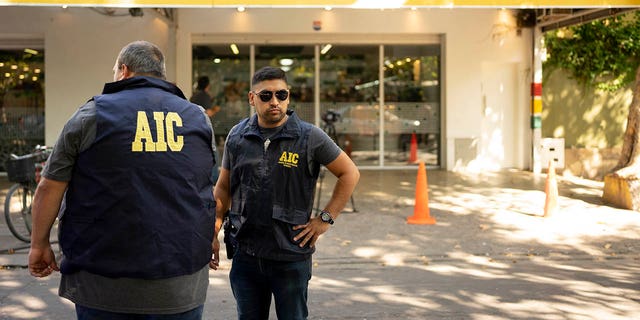 Police gather at the Unico supermarket, a grocery chain owned by soccer player Lionel Messi's in-laws, after it was shot at in Rosario, Argentina.