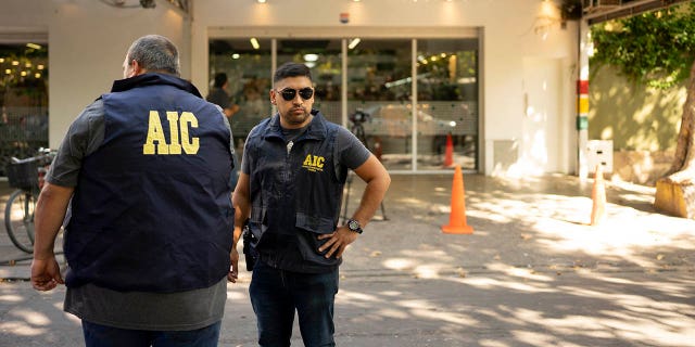 Police gather at the Unico supermarket, a grocery chain owned by soccer player Lionel Messi's in-laws, after it was shot at in Rosario, Argentina.