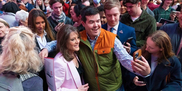 Marianne Williamson poses for a photo with a supporter as she launches her 2024 presidential campaign in Washington, DC, Saturday, March 4, 2023.