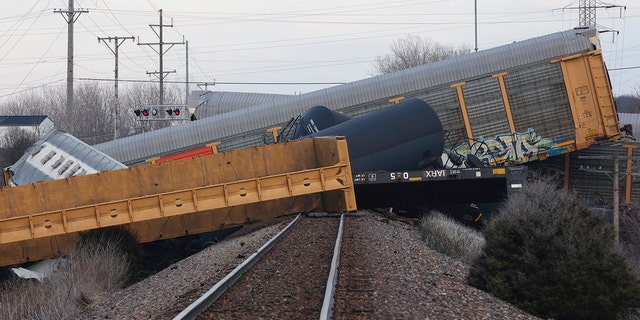 Multiple cars of a Norfolk Southern train lie toppled after derailing at a train crossing with Ohio 41 in Clark County, Ohio, March 4, 2023. 