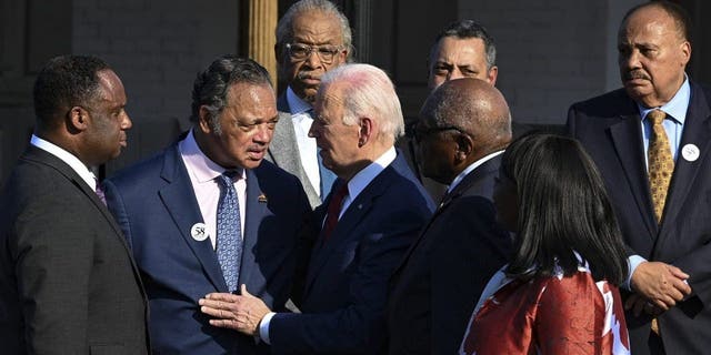 The Rev. Jesse Jackson, second from left, talks with President Joe Biden in Selma, Ala., Sunday, March 5, 2023, as Biden arrives to commemorate the 58th anniversary of "Bloody Sunday," a landmark event of the civil rights movement.