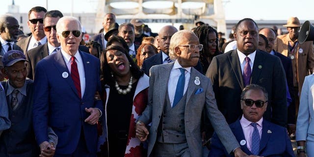 President Joe Biden walks across the Edmund Pettus Bridge in Selma, Ala., Sunday, March 5, 2023.