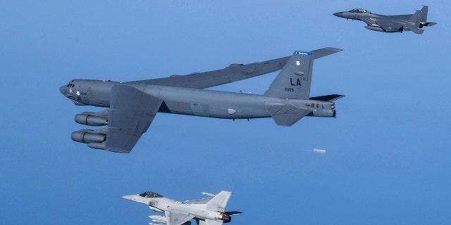 In this photo provided by South Korea Defense Ministry, a U.S. Air Force B-52H Stratofortress aircraft, center, flies in formation with South Korea's Air Force KF-16 fighters, bottom, and South Korea's Air Force F-15K fighters over the western sea of Korean peninsula during a joint air drill in South Korea, Monday, March 6, 2023. 